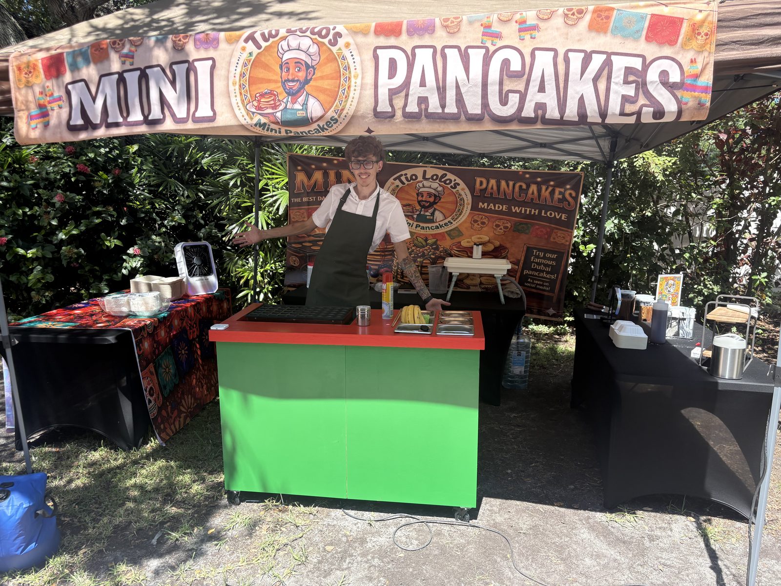 Tío Lolo's Mini Pancakes service cart with employee ready to serve