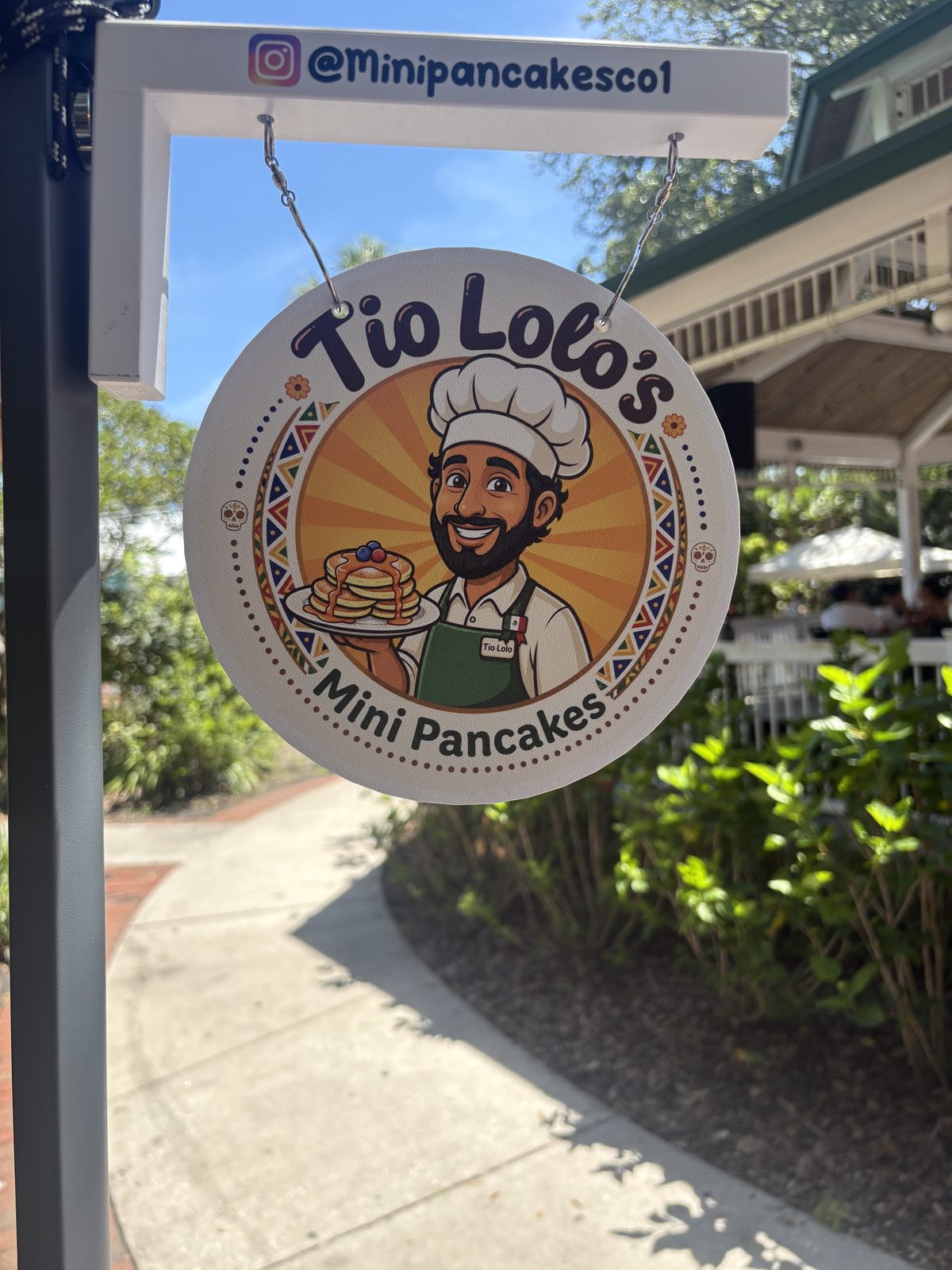 Tío Lolo's hanging sign with Instagram handle @Minipancakesco1